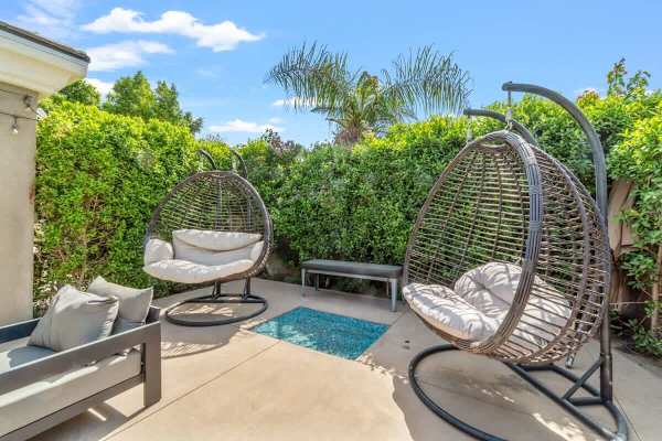 Swing gently under palms and string lights.