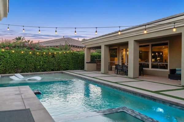 Covered patio provides shade while loungers catch full sun.
