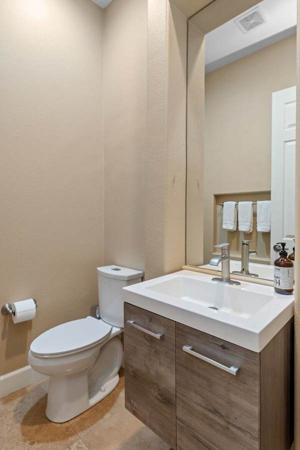 Bathroom with floating vanity and statement mirror.