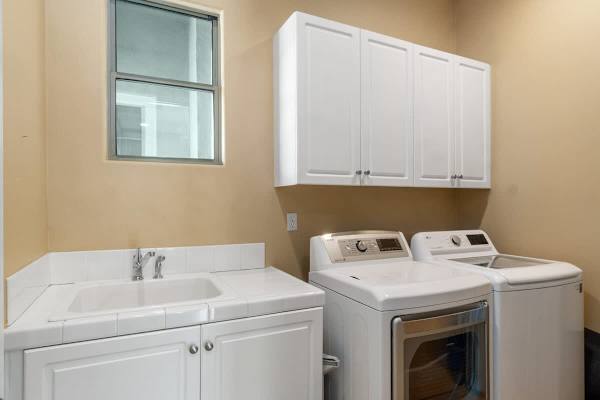 Full-size washer and dryer with storage cabinets—keep everyone's vacation wardrobe fresh and ready.