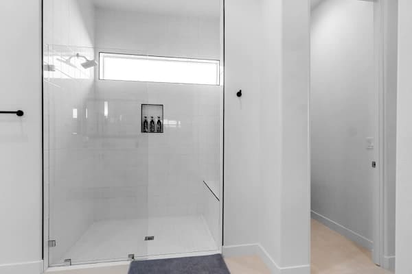 Walk-in shower with glass enclosure-