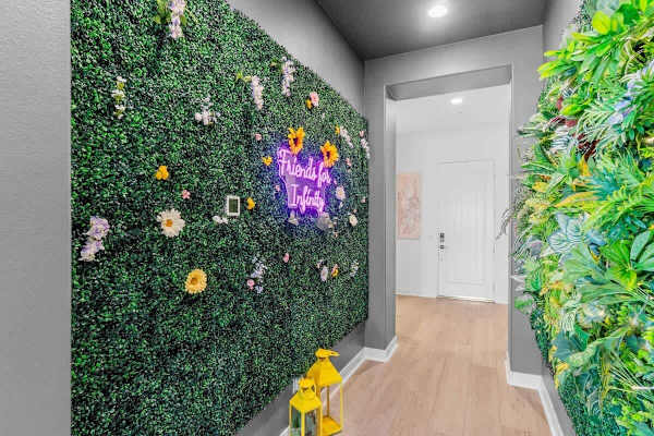 Bold floral wall and neon art greet you.