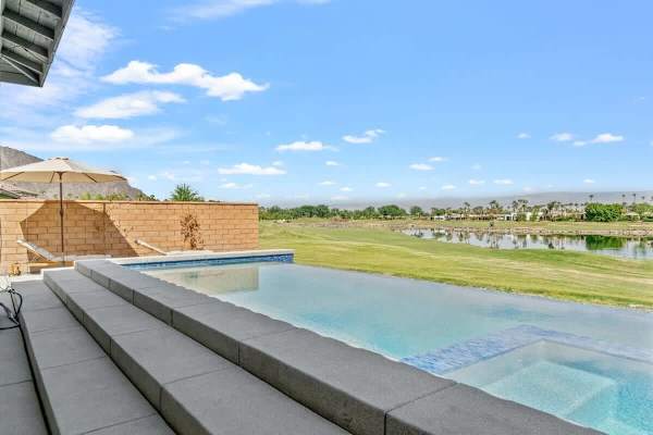 Infinity edge disappears into golf course views.