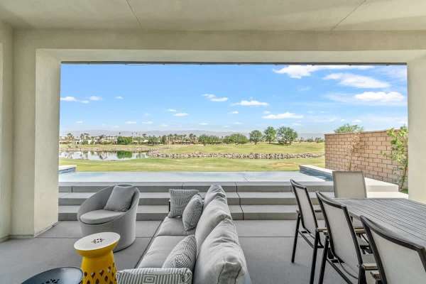 Covered patio overlooks fairway—sip morning coffee while golfers finish their rounds.