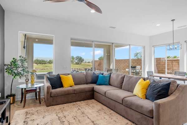 Sectional seating with yellow and teal pops.