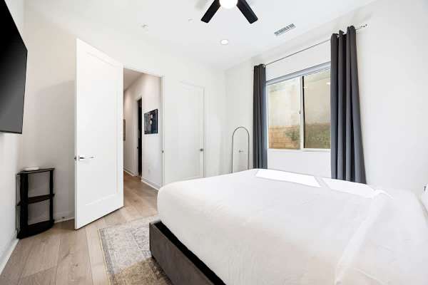 Bright, peaceful bedroom with natural light and modern comfort.