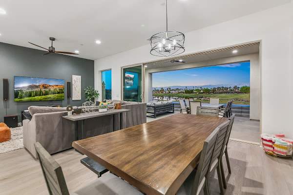 Living, dining, and kitchen connect with golf course panoramas.