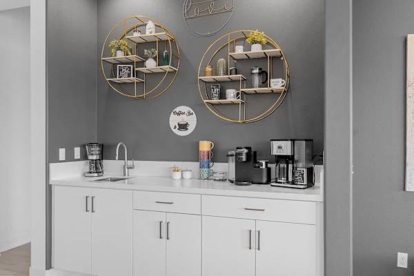 Built-in coffee bar with round mirrors—start mornings right with espresso and fairway views.
