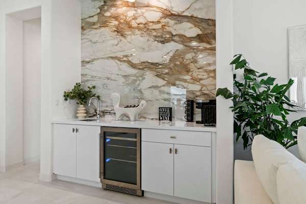 Start your morning with coffee at the built-in bar beneath stunning stone details.