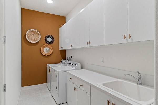 Full-size washer and dryer with wood accent wall—functional space with style to spare.