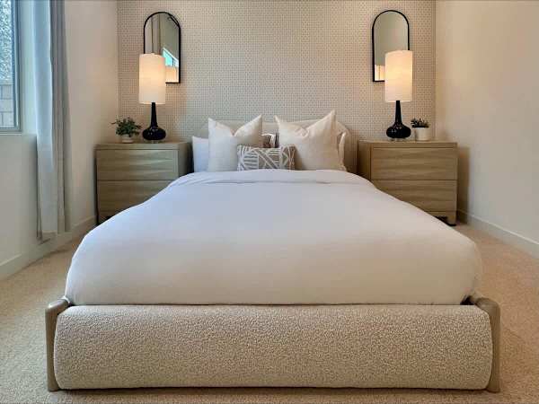 Soft bedding and warm lighting welcome all your guests.