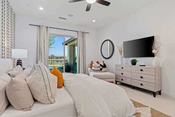 Primary with patio access and wall-mounted TV.