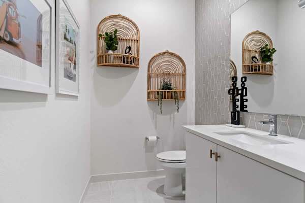 Half bath with woven wall baskets—charming boho touches make guests feel right at home.