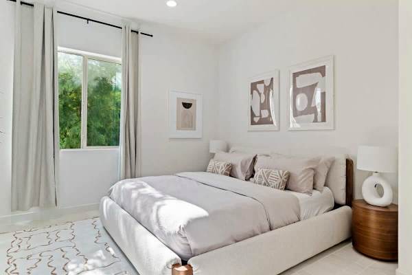 Minimalist guest room with garden views.