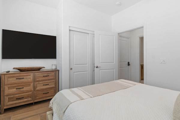 Bedroom 3 features a queen-size bed and a TV.