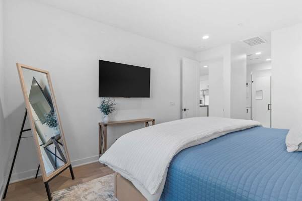 Navy blue runner across white bedding.