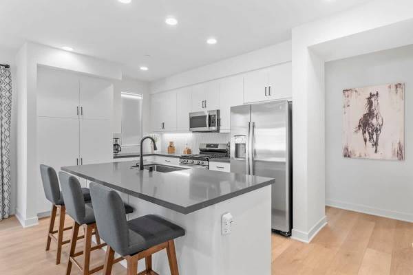 Bar height seating is available for three from the kitchen Island.