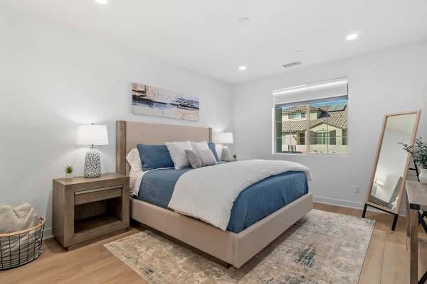 Primary bedroom with blue accent bedding.