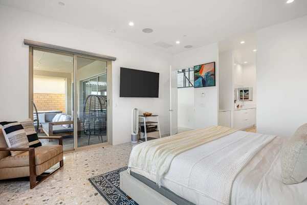 Spacious bedroom with comfortable bed and TV for a restful night's sleep.