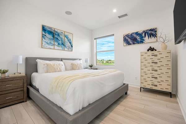 Serene bedroom with golf course views and contemporary décor for peaceful sleep.