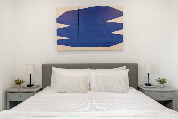 Modern bedroom with bold artwork and comfortable bed for restful nights ahead.