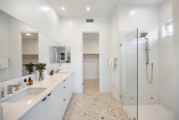 Modern primary bathroom with dual sinks and walk-in shower for easy mornings.