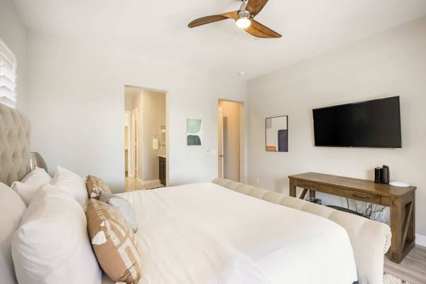 A restful master suite with a TV for your enjoyment.