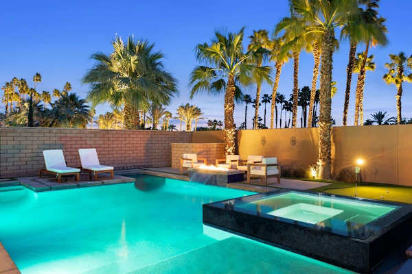 Private pool and spa at sunset with warm light around the area.