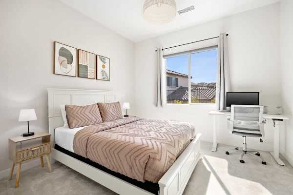 Bright second bedroom with a comfortable queen-size bed.