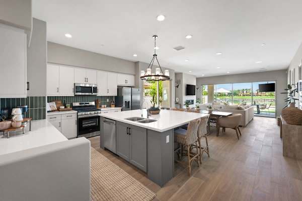 Modern kitchen with large island, lake views, and everything you need to cook.