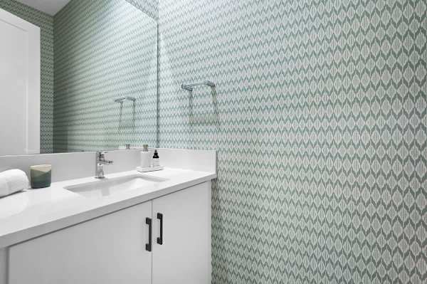 Half bathroom with modern tile and clean lines makes hosting guests easy here.