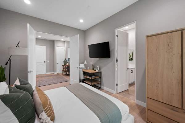 This queen bedroom offers closet space, TV, and access to the bathroom for added convenience.