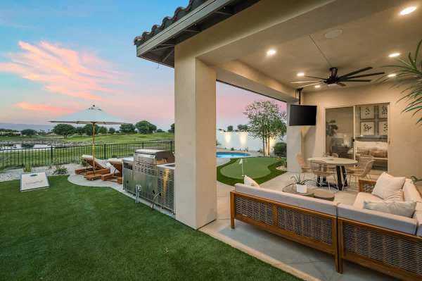 Covered patio with lake views becomes the heart of every evening at this home.