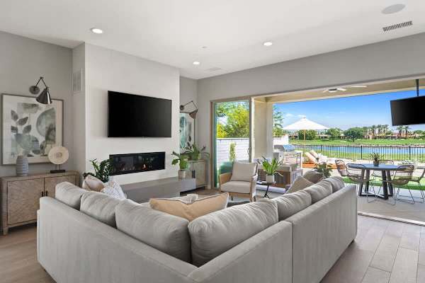 Living area with wall-mounted TV, and direct patio access for easy indoor-outdoor flow.