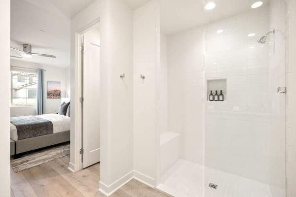 Primary bathroom features a spacious walk-in shower with rainfall showerhead.