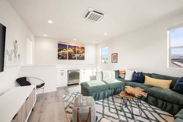 Upstairs loft with sectional sofa and TV creates a second living space perfect for movie marathons.