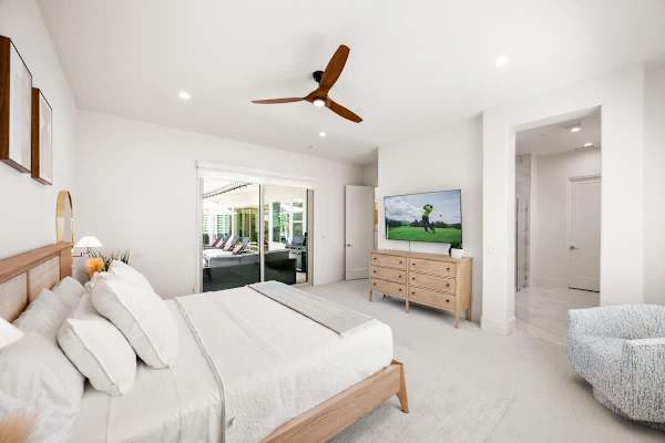 Simple and peaceful master suite bedroom with a king bed and TV.