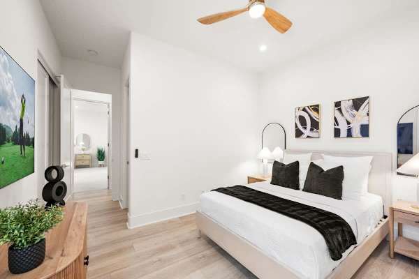 Cozy sleeping space with a queen bed and TV for relaxing nights.