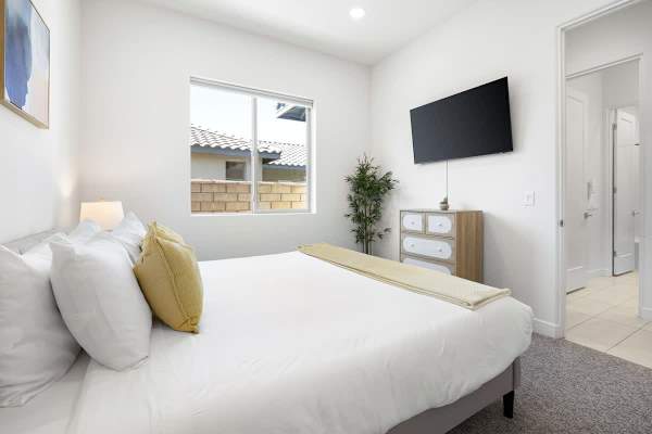 Second bedroom with TV provides a bright, comfortable space for guests to call their own here.