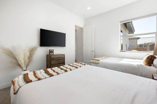 Guest bedroom with TV, and shared nightstand gives everyone their own spot to rest.