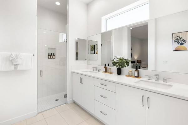 Primary bathroom with double vanity, and walk-in shower feels like a luxury spa right in your room.
