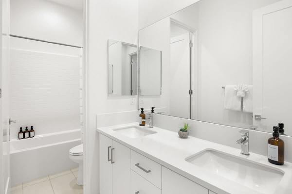 Full hallway bathroom with double vanity serves the secondary bedrooms with ease and style.