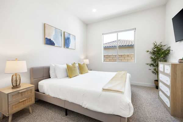 Second bedroom with queen bed, natural light, and clean lines provides a comfortable retreat.