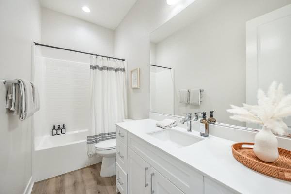 Clean and bright full bathroom with a tub/shower combo.