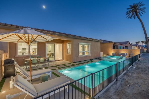 The home is beautifully illuminated in the evening.