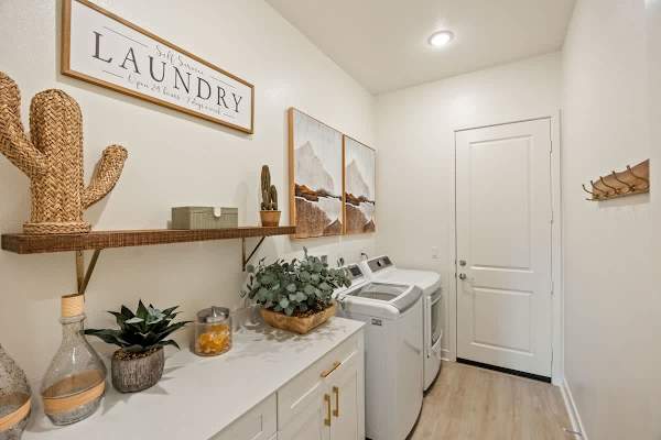 Laundry room features washer and dryer, laundry pods, iron, and ironing board to meet your needs.