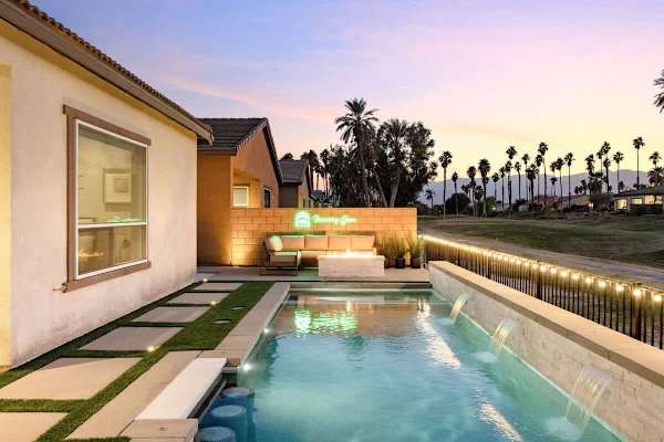 The home is beautifully illuminated in the evening.