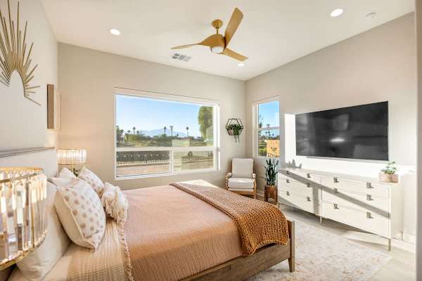 Spacious Master Suite with plush bedding and a flat-screen TV.