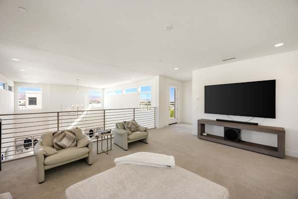 Head upstairs to the media room with sweeping views over the main living spaces below.