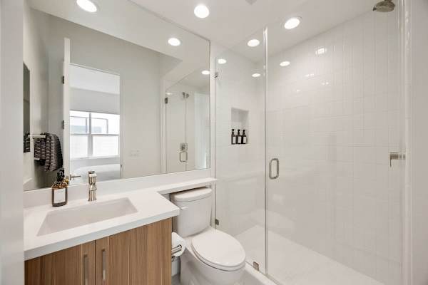 This en-suite bathroom has everything—shower-tub combo and plenty of counter space.